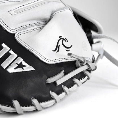 Close-up of the All Star PHX 33″ Paige Halstead Fastpitch Catcher’s Mitt (CMW-PHX-33) in black and white, highlighting its detailed stitching, distinctive wave-like logo on the palm, and an adjustable pocket system designed by All Star for an ideal fit during travel ball play.