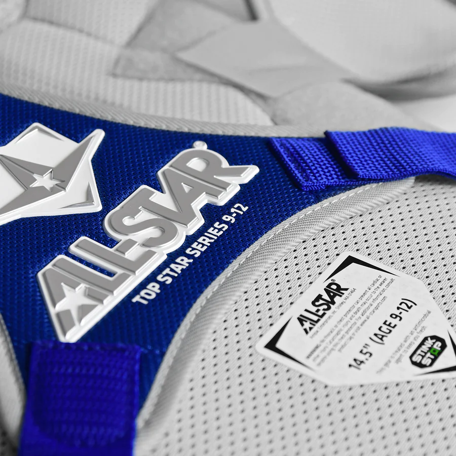 A close-up of the All Star Top Star Catcher's Chest Protector (CPCC-TS) in blue and white, designed by All Star for travel ball catchers and offering robust NOCSAE-compliant protection.
