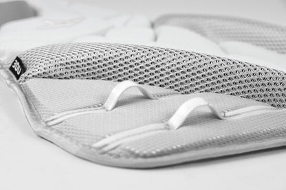 Close-up of a white and gray padded mesh fabric with two white loops and detailed stitching from the All Star PHX Paige Halstead Fastpitch Catcher's Chest Protector: CPW-PHX by All Star, shown on a plain background.