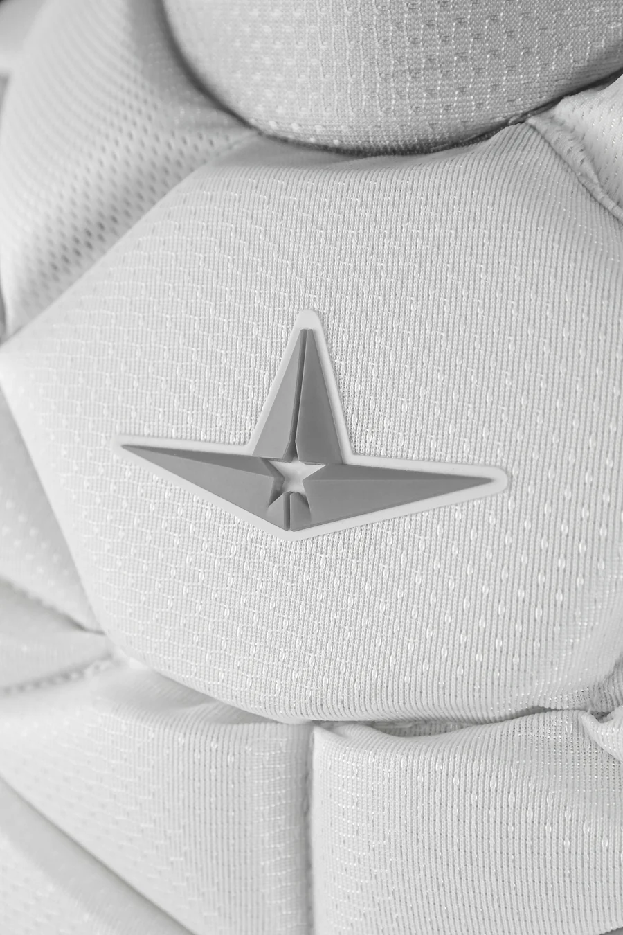 Close-up of the All Star PHX Paige Halstead Fastpitch Catcher's Chest Protector (CPW-PHX) in textured white fabric with a 3D gray star emblem—perfect for fastpitch catchers seeking Paige Halstead–inspired gear.