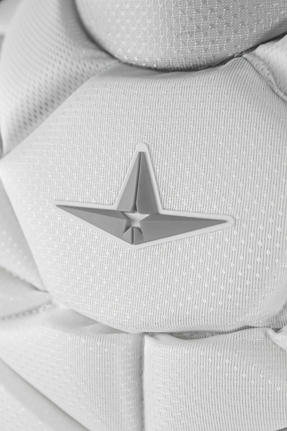 Close-up of the All Star PHX Paige Halstead Fastpitch Catcher's Chest Protector (CPW-PHX) in textured white fabric with a 3D gray star emblem—perfect for fastpitch catchers seeking Paige Halstead–inspired gear.