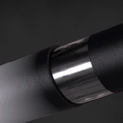 A close-up of a metallic cylindrical object with a shiny, reflective surface and matte black sections on either side, set against a dark background.