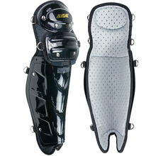 The All Star Cobalt Pro Umpire Leg Guards (LGU5000) are shown in black. One highlights the hard outer shell, while the other displays a padded, light gray interior with ventilation holes for comfort and breathability.
