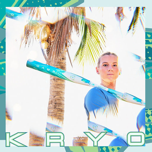 A woman in blue athletic wear stands by a palm tree, holding a long object labeled KRYO. The image has bright, warm lighting and a geometric border. The word KRYO appears at the bottom.