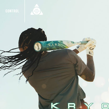 Wearing a dark shirt and batting gloves, a person with long braids swings the 2026 Louisville Slugger Kryo (-8) Fastpitch Softball Bat (WBL4137010) as sunlight shines from behind.