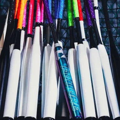 A row of baseball and softball bats with colorful handles, mostly white barrels, and one bat in the center with a metallic blue design and the word FUTURE written on it.