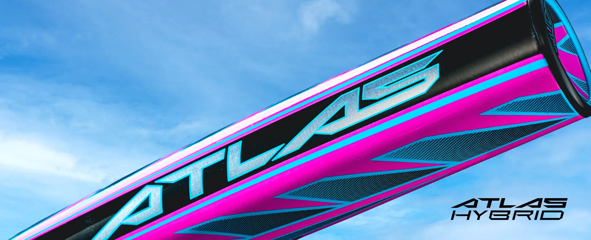 A close-up of a pink, blue, and black baseball bat with the word ATLAS in bold letters, set against a bright blue sky. The text ATLAS HYBRID appears in the bottom right corner.