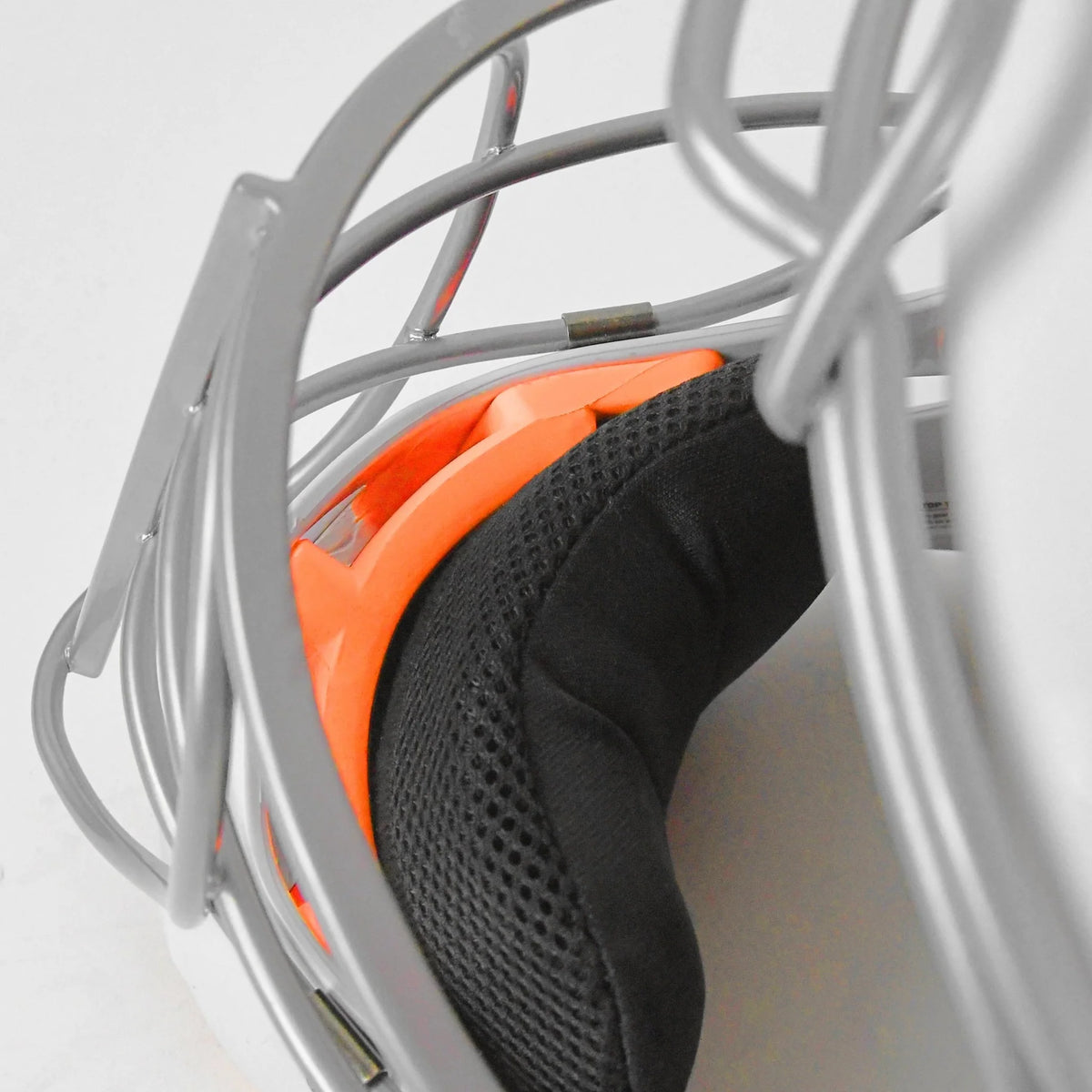 Close-up view of the interior padding and metal faceguard of the All Star PHX Paige Halstead MVP Pro Lite Hockey Style Catcher’s Helmet (MVP-5-PHX-LT), showcasing orange and black foam cushioning in a Paige Halstead inspired design.