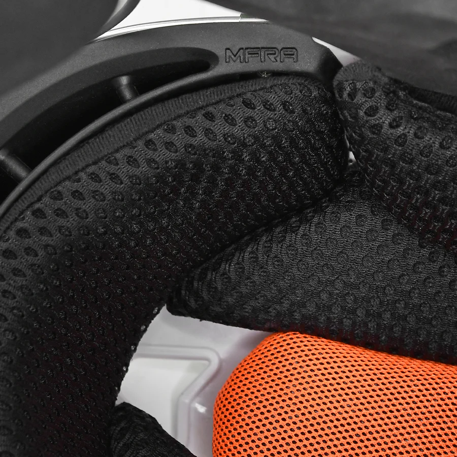 Close-up of the interior padding on the All Star PHX Paige Halstead MVP Pro Hockey Style Catcher's Helmet (MVP5-PHX), showing black textured foam, an orange mesh pad, and "MFRA" on a black plastic part.
