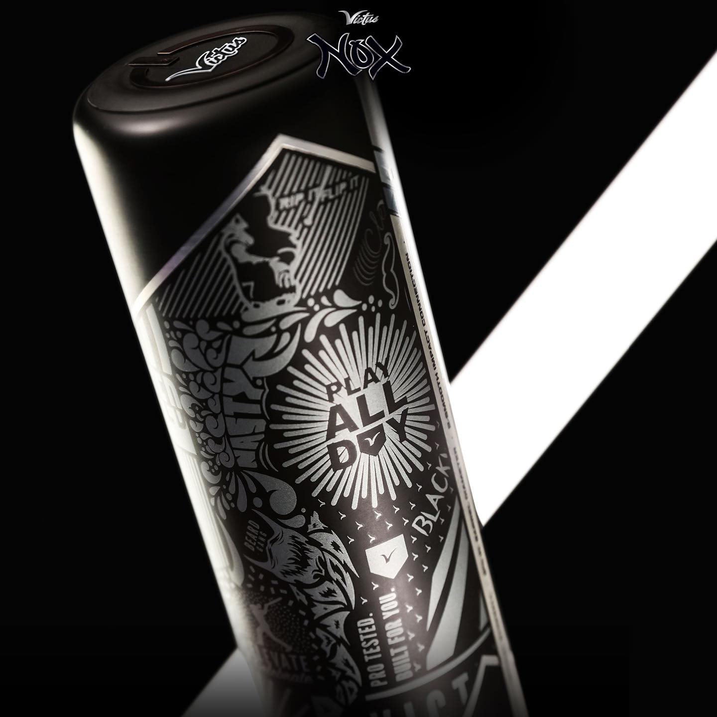 A black canister with intricate white geometric and graphic designs and the words “PLAY ALL DAY” in bold, positioned against a black background with diagonal white lines.