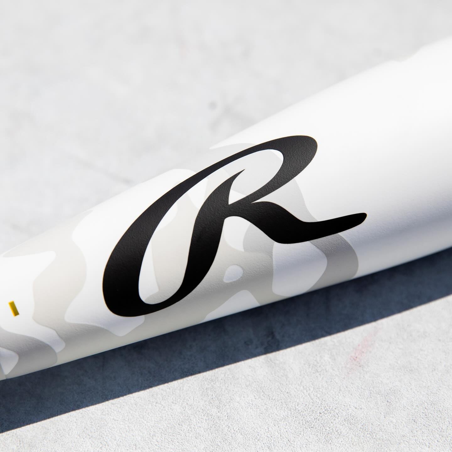 A white Rawlings 2025 Icon (-5) USSSA baseball bat (2 3/4", RUT5I5) with black lettering.