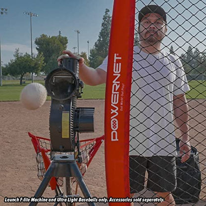 A man prepares for batting practice next to a PowerNet Launch F-Lite Pitching Machine and a bucket of PowerNet 1194-1 baseballs.