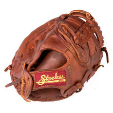 The Shoeless Joe 12" Baseball First Base Mitt (1200FB) features brown leather, a Tennessee Trapper pocket, woven laces, and a red and yellow Shoeless Joe patch by the wrist, displayed against a white background.