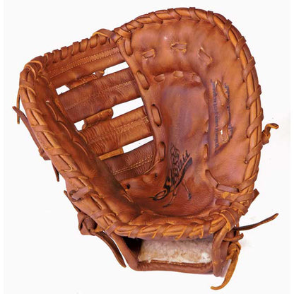 A Shoeless Joe 12" Baseball First Base Mitt (1200FB) made of brown leather with visible stitching and laces sits open, palm-up, showing signs of use and featuring a classic Tennessee Trapper pocket.