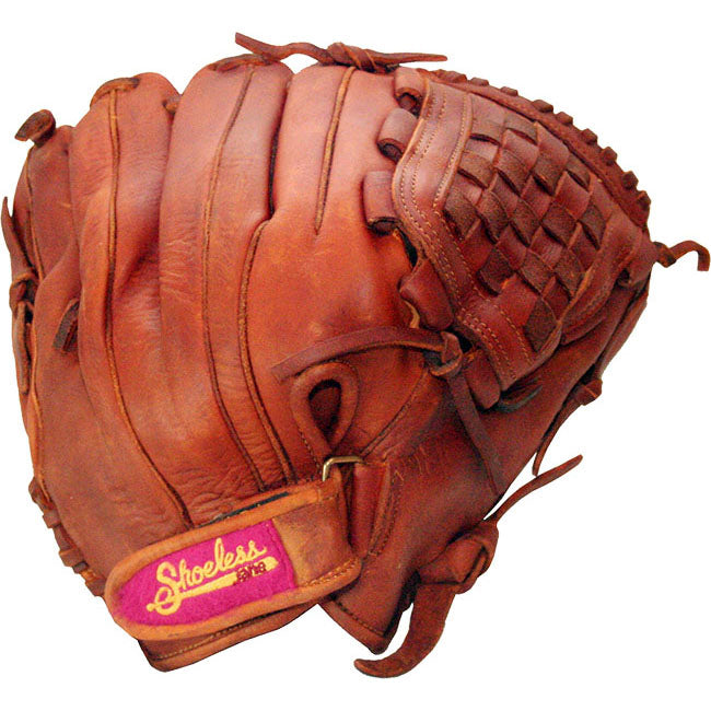 A worn brown leather Shoeless Joe 12" Fastpitch Glove (1200FPBW) with visible stitching and a patch reading "Shoeless" in yellow on a red background near the wrist strap.