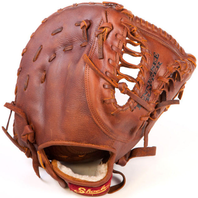 A Shoeless Joe 13" Baseball First Base Mitt (1300FBTT) by Shoeless Joe, crafted from brown leather with visible stitching and laces. The open glove displays its palm, pocket, interior lining, and signs of use.