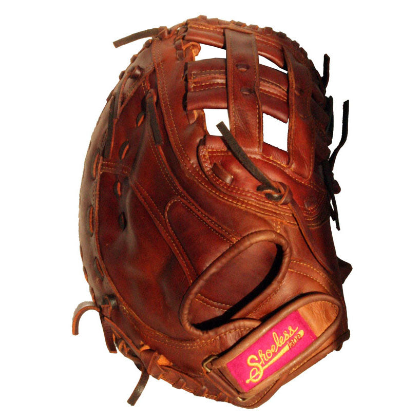 A brown Shoeless Joe 13" Fastpitch First Base Mitt (1300FPFB) with black laces and a pink and yellow wrist label, inspired by classic Shoeless Jane women's softball gloves.