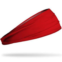 The Junk True Red Headband by Junk, a wide and stretchy athletic accessory, is shown on a white background, appearing slightly elevated as if floating.
