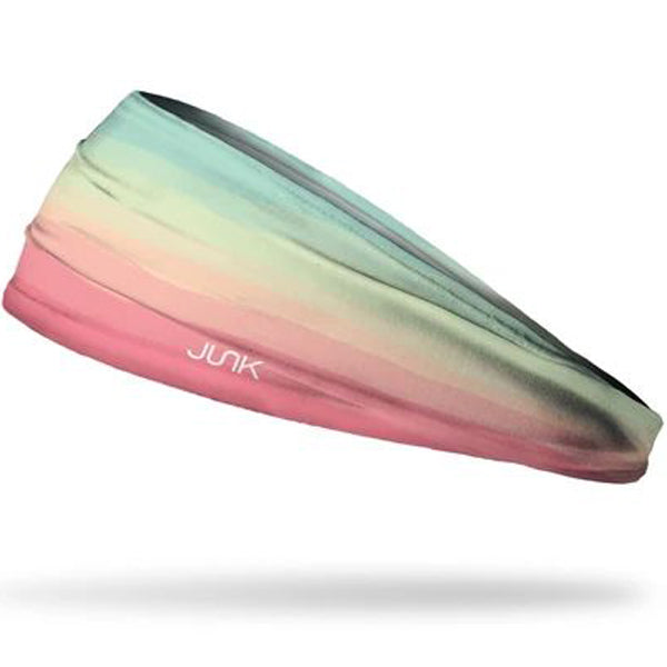 The Junk Boca Headband by Junk features a multicolored gradient from teal and light green to pink, crafted from technical t-shirt fabric for superior sweat-wicking with a white JUNK logo on the side.