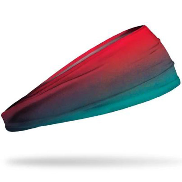 The Junk Bora Bora Headband by Junk is a stretchy, moisture-wicking athletic headband featuring a gradient design that fades from red to teal, shown on a white background.