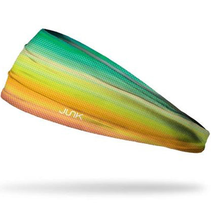 The Junk Citrus Headband by Junk is a wide athletic headband made from technical t-shirt fabric, showcasing a green-yellow-orange gradient with small dots and the white JUNK logo.