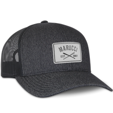 The Marucci Cross Patch Snapback Hat (MAHTTRPCS) is a black trucker mesh baseball cap with a light gray front patch displaying the Marucci logo above crossed bats and "EST. MMIV," plus an adjustable snapback closure.