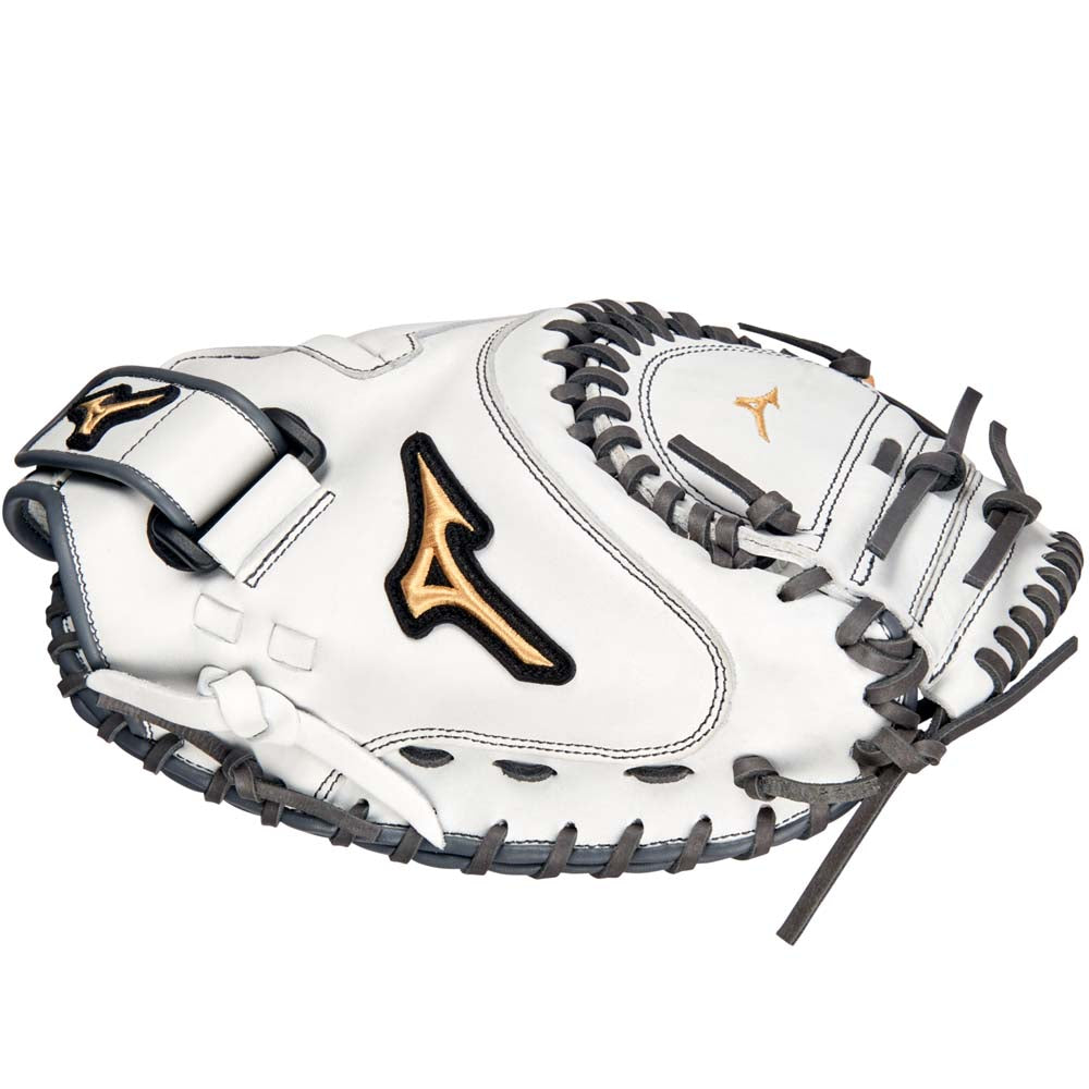 The Mizuno MVP Prime 34" Fastpitch Catcher's Mitt (GXS50PF4W) is a white glove with black laces, gold and black accents, a center pocket design, and stylized gold logos on the side and near the webbing.