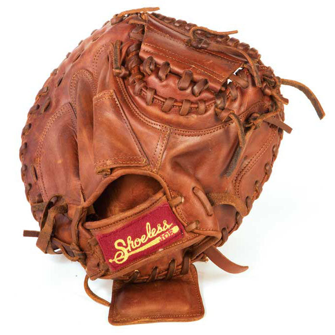 The Shoeless Joe 32" Baseball Catcher's Mitt: 3200CM, crafted from tobacco tanned steerhide with visible stitching and lace details, features a red and yellow Shoeless patch on the wrist, reflecting Shoeless Joe’s signature quality.