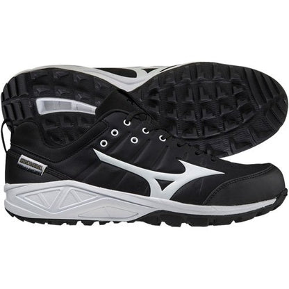A pair of Mizuno Ambition 2 All Surface Low Men's Turf Shoes 320632 in black with white soles and side logos, designed for superior traction; one shoe is shown from the side, the other displays the textured sole.
