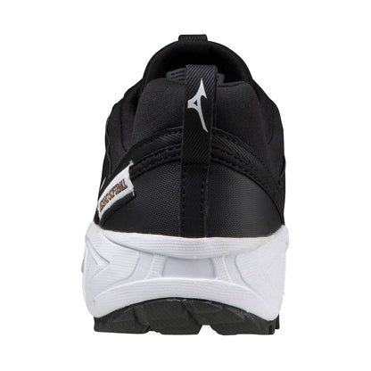 Rear view of the Mizuno Ambition 2 All Surface Women's Turf Shoe in black with a white sole, Mizuno-branded pull tab on the heel, and a small WAVE REVOLT label on the side. The background is plain white.