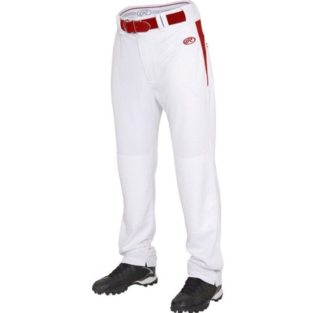 The image shows the lower half of a person wearing Rawlings Adult BPVP2 Semi-Relaxed Baseball Pants in white with red side stripes, red belt, black cleats, Rawlings logo on the left thigh, and reinforced knees for durability.