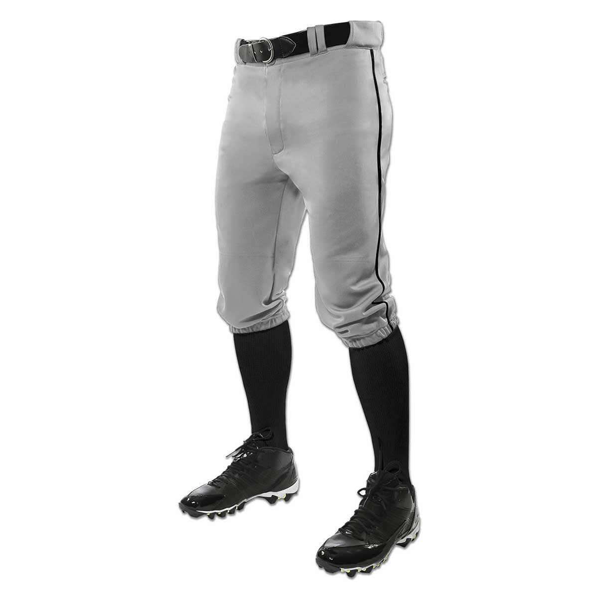 A person wears Champro Sports’ Triple Crown Knicker Baseball Pants with Piping (BP101A) in gray, paired with a black belt, black knee-high socks, and black cleats, shown waist down against a white background.