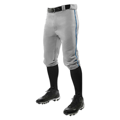 A person models Champro Sports' Adult Triple Crown Knicker Baseball Pants with Piping (BP101A)—gray, pro-weight fabric with thin blue stripes—paired with a black belt, black knee-high socks, and black cleats against a white background.
