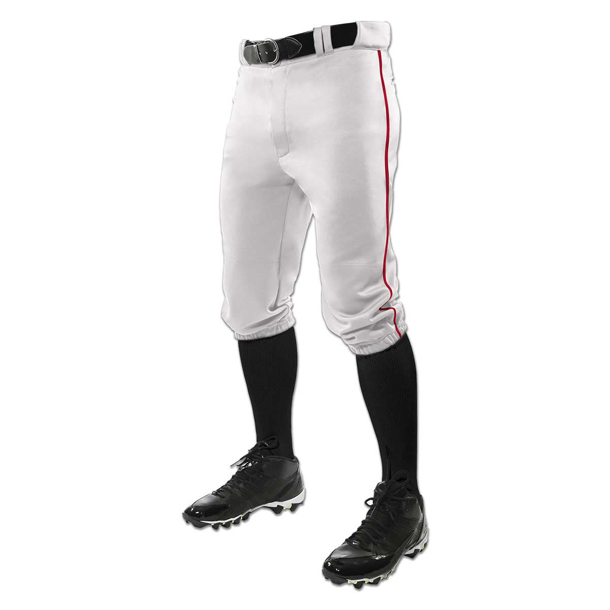 A person wearing Champro Sports Triple Crown Knicker Baseball Pants with red piping (BP101A), a black belt, black knee-high socks, and black cleats, shown from the waist down against a white background.