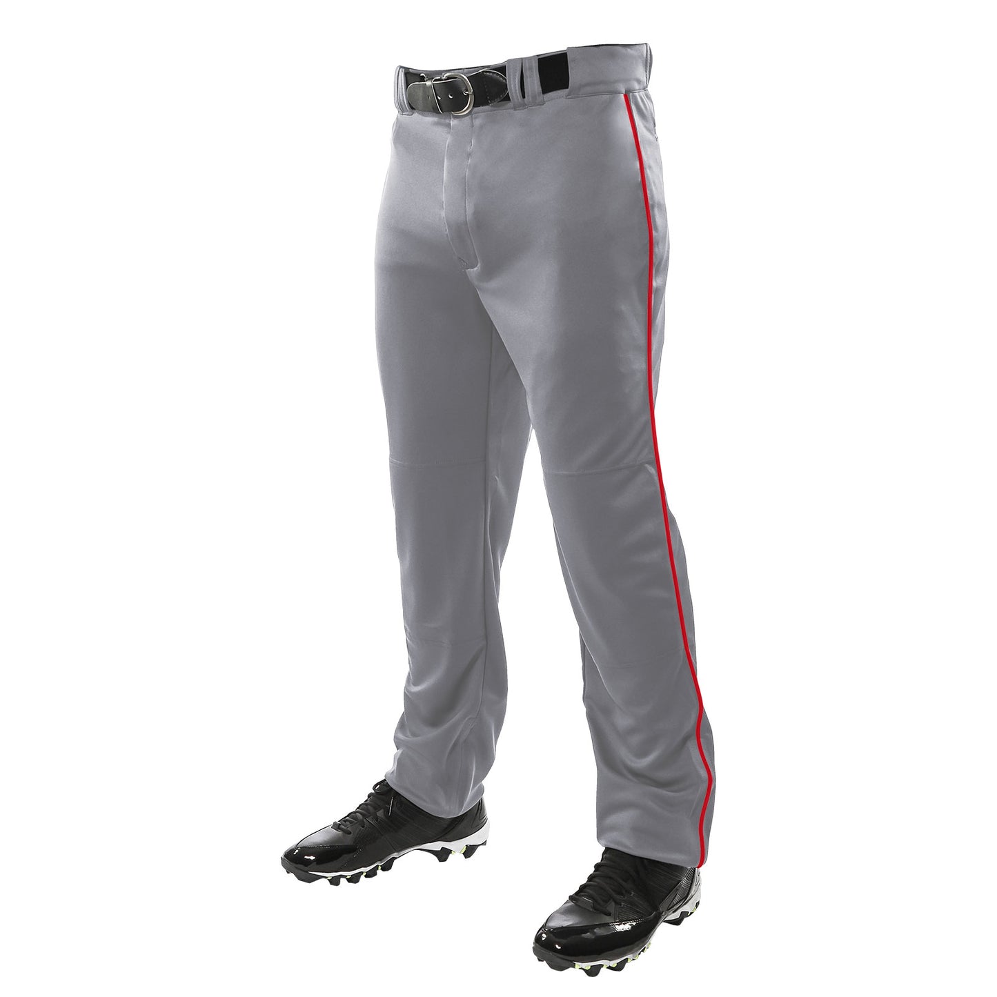 A person wears Champro Sports Triple Crown Open Bottom Baseball Pants with red piping (BP91UA), paired with a black belt and black cleats. The photo shows only their lower body, waist down.