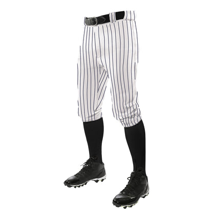 A person wears Champro Sports Triple Crown Pinstripe Knicker Baseball Pants (BPPINKA) in white with black pinstripes, a black belt, black knee-high socks, and cleats—shown waist down on a white background.