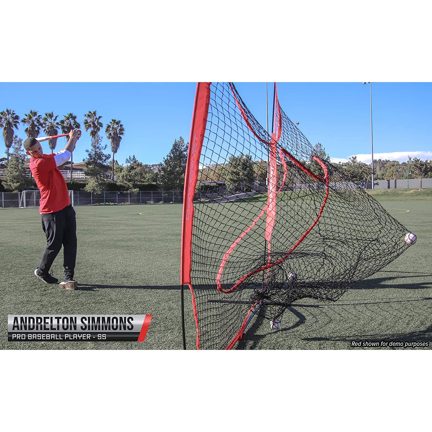 A baseball player in a red shirt and black pants bats on grass, hitting into a PowerNet 7' x 7' Practice Hitting Net by PowerNet under a clear sky. Text reads: Andrelton Simmons, Pro Baseball Player - SS.