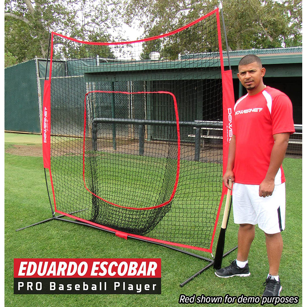 A man in a red shirt and white shorts stands beside a PowerNet 7' x 7' Practice Hitting Net (1001) by PowerNet on a grass field, holding a bat. A dugout and trees are in the background. Text: Eduardo Escobar PRO Baseball Player.