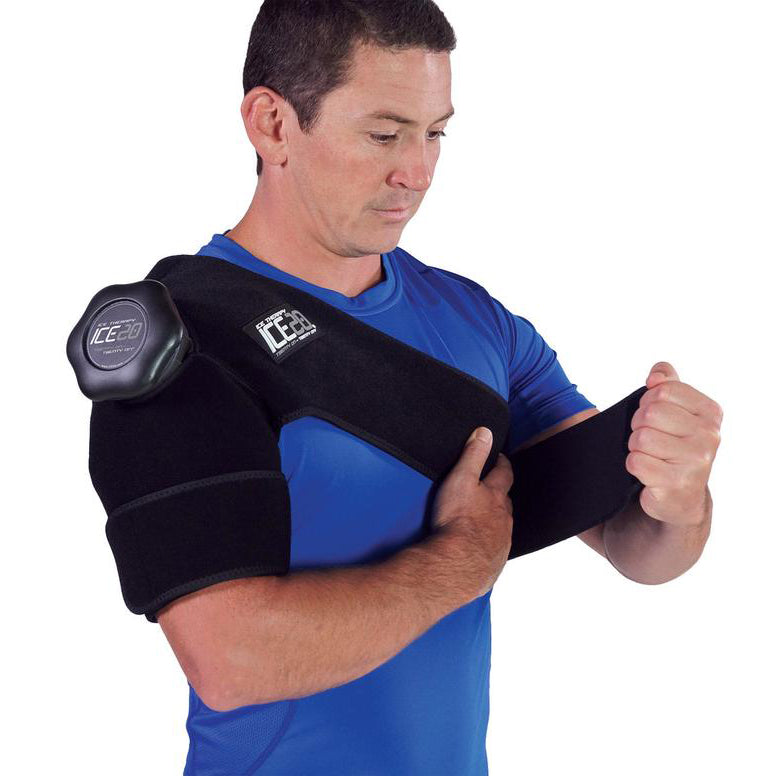 A man in a blue shirt puts on the Bownet ICE20 Single Shoulder Ice Compression Wrap (ICE-Shoulder), securing the strap across his chest for targeted relief with the attached ice pack.