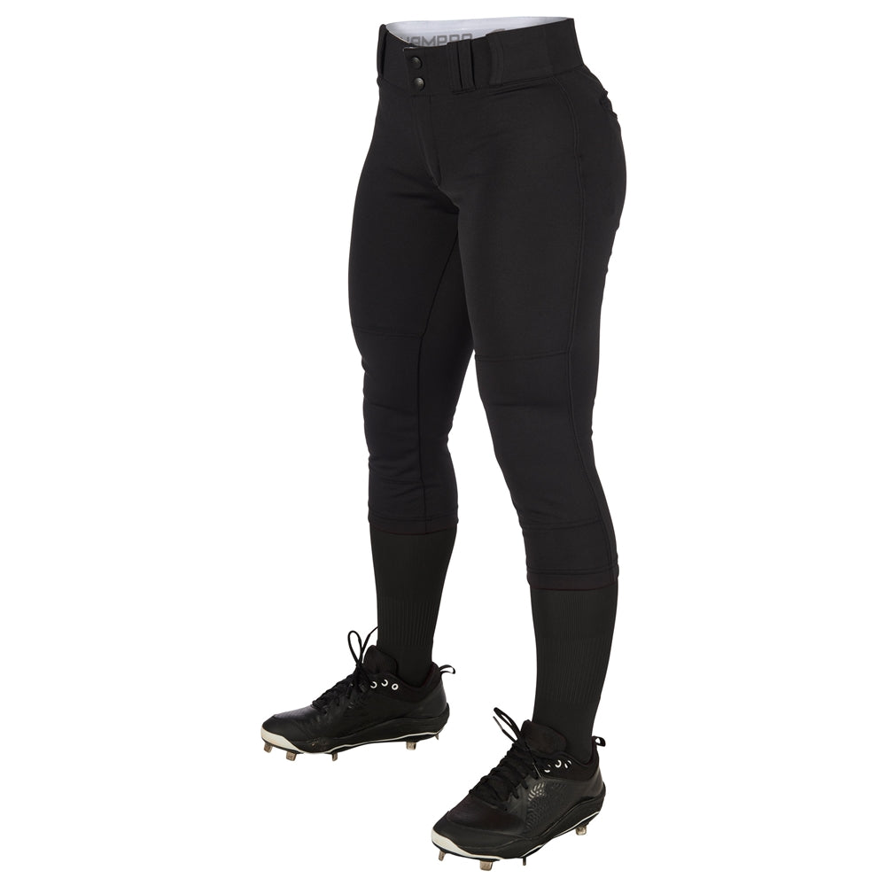 A person wearing Champro Sports Women's Low Rise Tournament Fastpitch Softball Pants (BP11W) in black, along with black socks and cleats, stands against a white background. Only the lower body is visible.