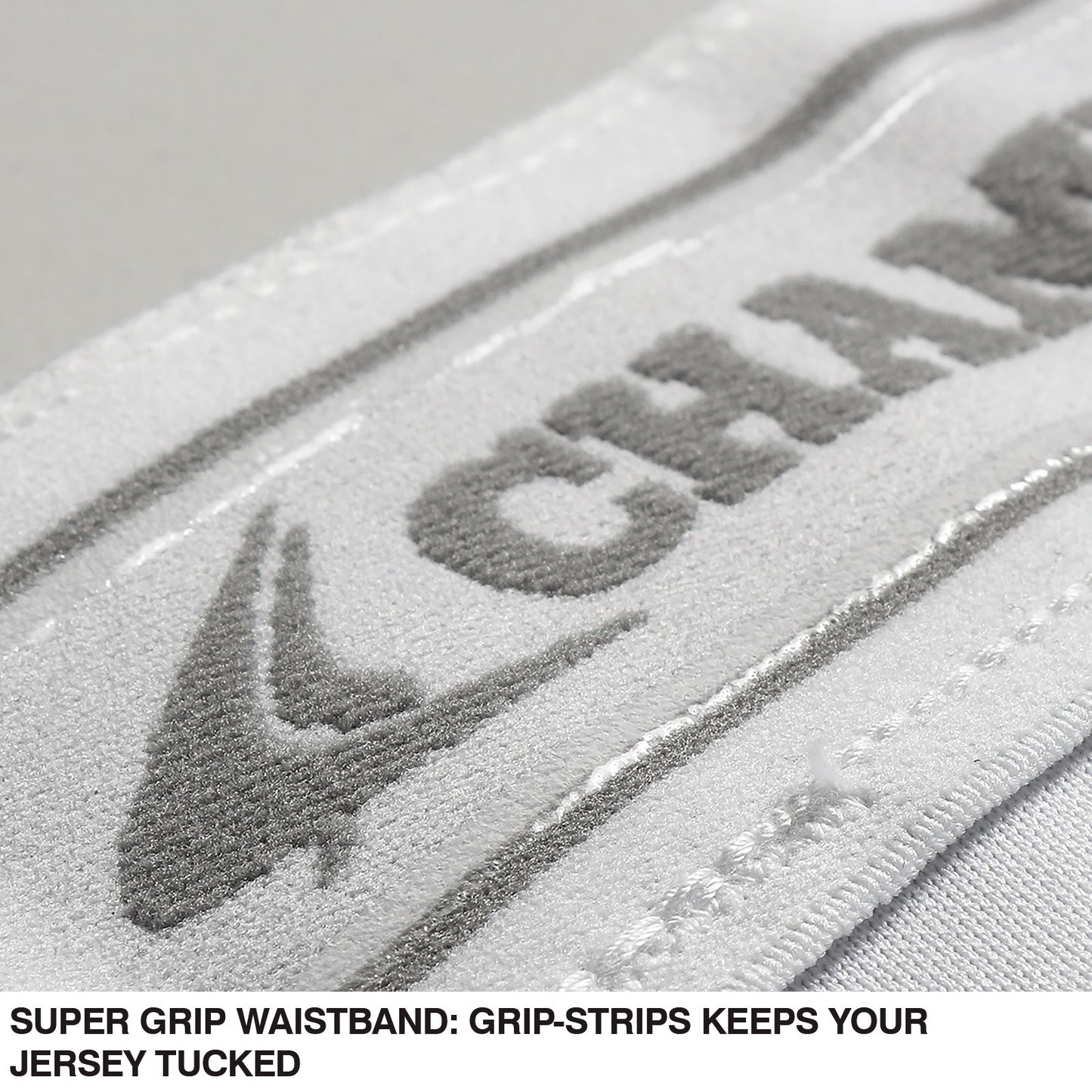 Close-up of a white waistband with CHAMPRO SPORTS in gray textured lettering and a grip-strip. Text below: SUPER GRIP WAISTBAND keeps your jersey tucked—designed for Champro Sports Girl's Low Rise Tournament Fastpitch Softball Pants (BP11G).