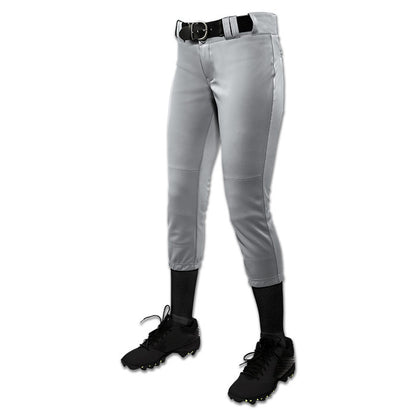 A person stands against a white background wearing Champro Sports Girl's Low Rise Tournament Fastpitch Softball Pants (BP11G), with pro-style tunnel belt loops, black socks, black cleats, and a black belt. The upper body is not visible.
