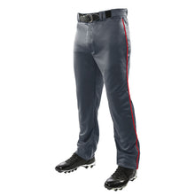 A person wearing Champro Sports Adult Triple Crown Open Bottom Baseball Pants with red piping (BP91UA), made of double-knit polyester. The photo is cropped at the waist, showing only lower body, black belt, and black cleats.