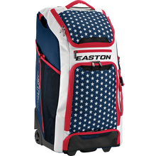 The Easton A159058 CATWB Catcher's Wheeled Bag features a blue, white, and red color scheme with white stars on blue, red zippers, rugged inline wheels, a telescopic handle, and EASTON branding displayed on the front.