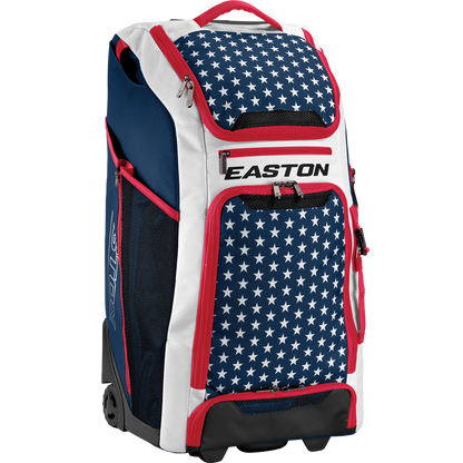 The Easton A159058 CATWB Catcher's Wheeled Bag features a blue, white, and red color scheme with white stars on blue, red zippers, rugged inline wheels, a telescopic handle, and EASTON branding displayed on the front.