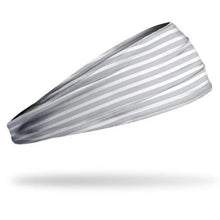 The Junk Costal Route Headband by Junk, featuring gray and white stripes and made from sweat-wicking technical t-shirt fabric, is shown against a white background with a subtle shadow underneath.
