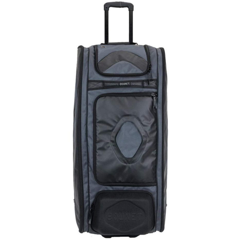 The Bownet Commander Wheeled Catcher's Bag (BN-COMMANDER BAG) by Bownet is a large, upright black and gray equipment bag with a retractable handle, front zippered pockets, and reinforced corners, shown on a white background.