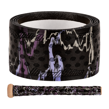 The Lizard Skins DSP Ultra Camo 1.1mm Bat Grip, in black with purple, white, and tan camo plus black polka dots, is shown rolled up and wrapped on a wooden bat handle.