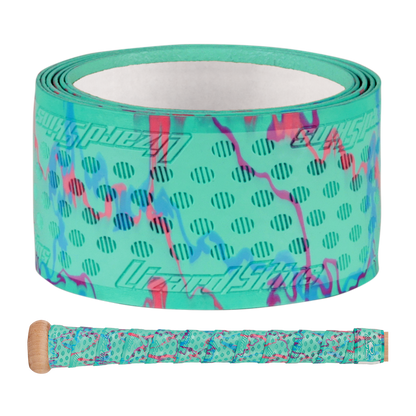 The Lizard Skins DSP Ultra Camo 1.1mm Bat Grip features turquoise polymer with purple and pink camo patterns, black polka dots, and branding. A sample shows the grip wrapped around a handle below the roll.