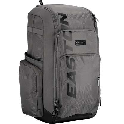 The Easton Roadhouse Backpack (EBA004) by Easton is a gray slowpitch backpack with multiple zippered compartments, side pockets, and "EASTON" printed vertically in black—ideal as a baseball or softball backpack.